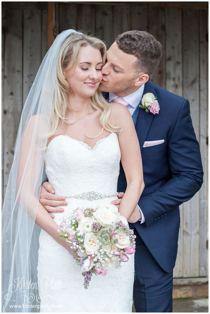 Groom give bride a kiss