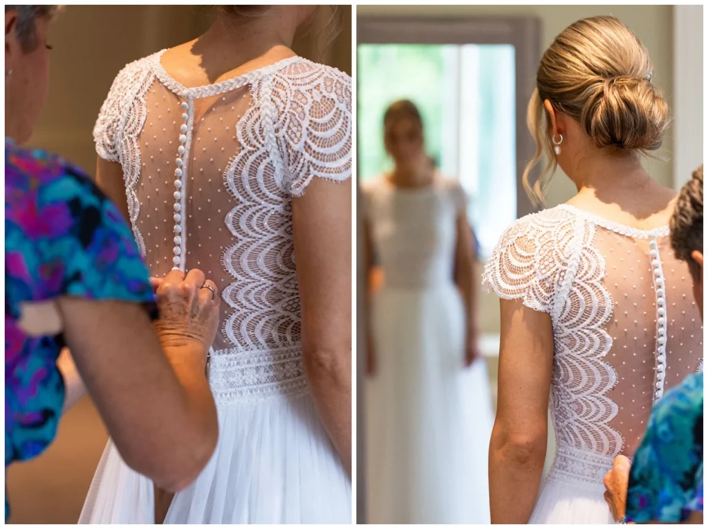 The brides mother fastening all the little buttons on the brides dress