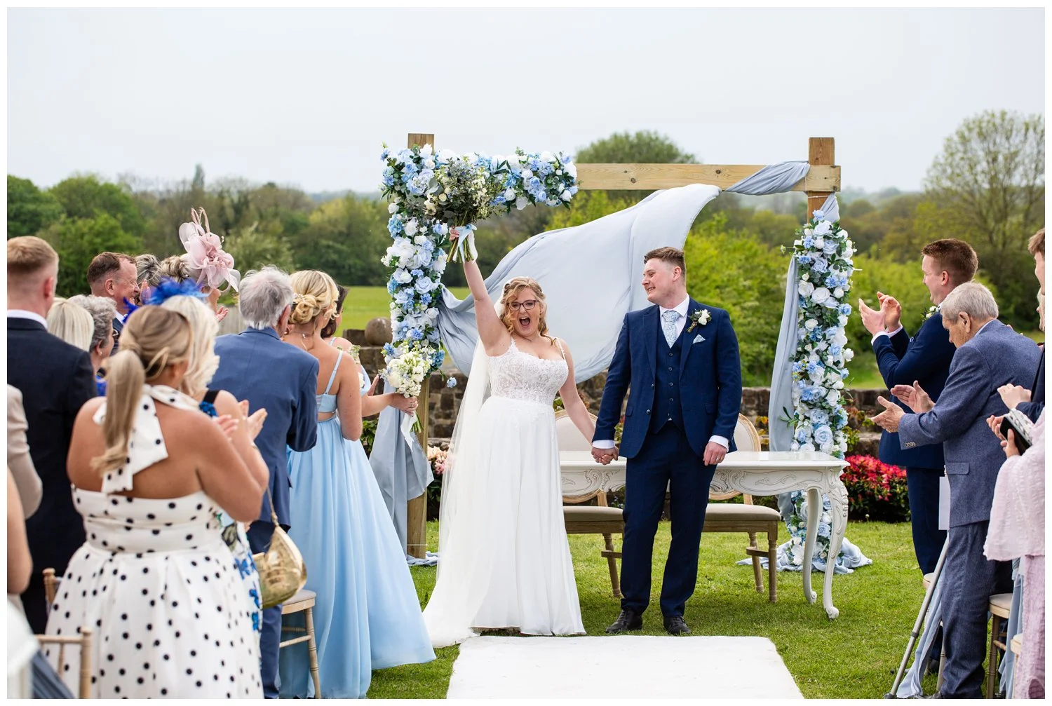 Bride and groom flower punch while walking down the isle